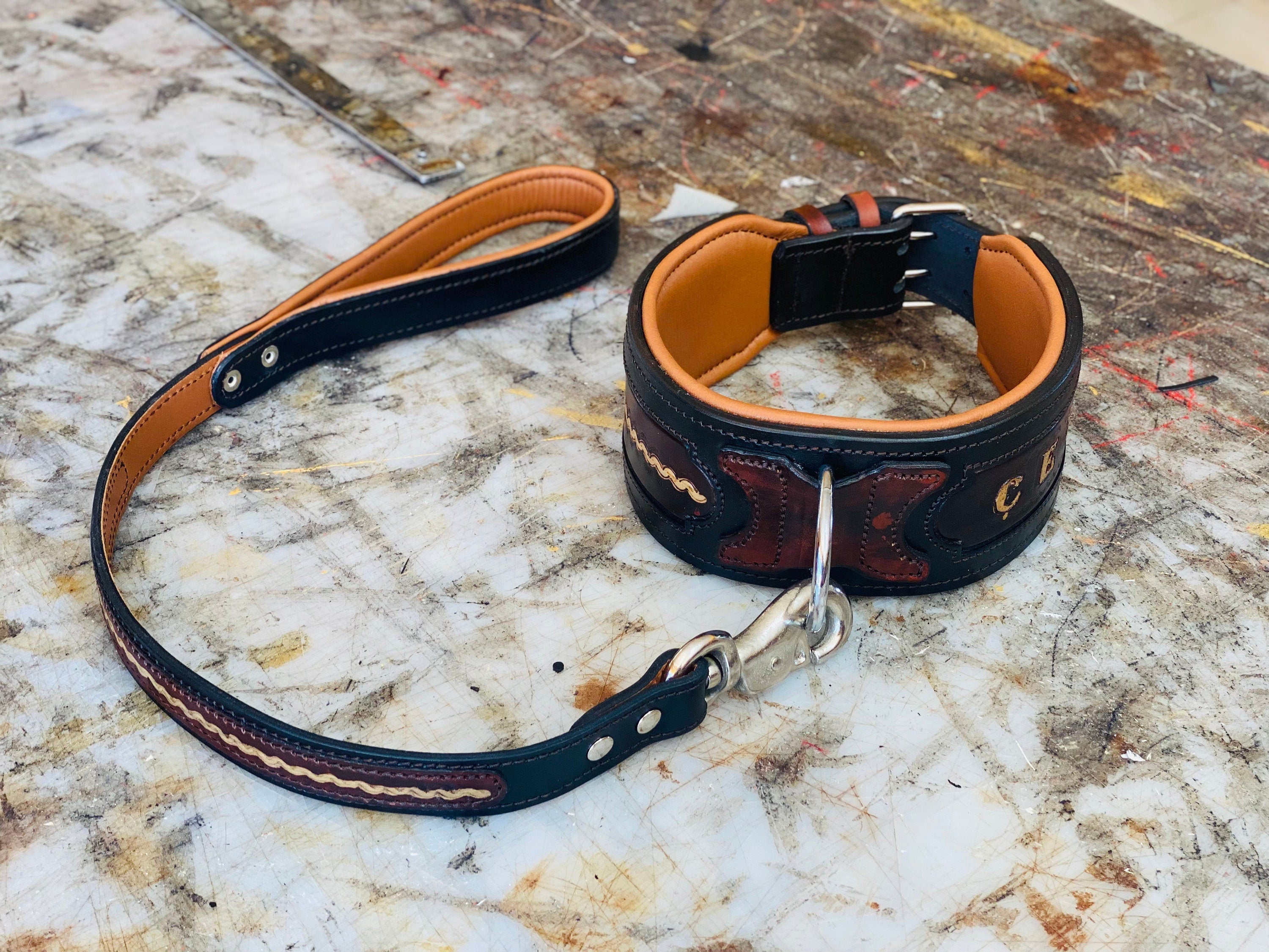 Handmade leather dog collar with custom engraved name plate and metal buckle, designed for durable and stylish pet wear.